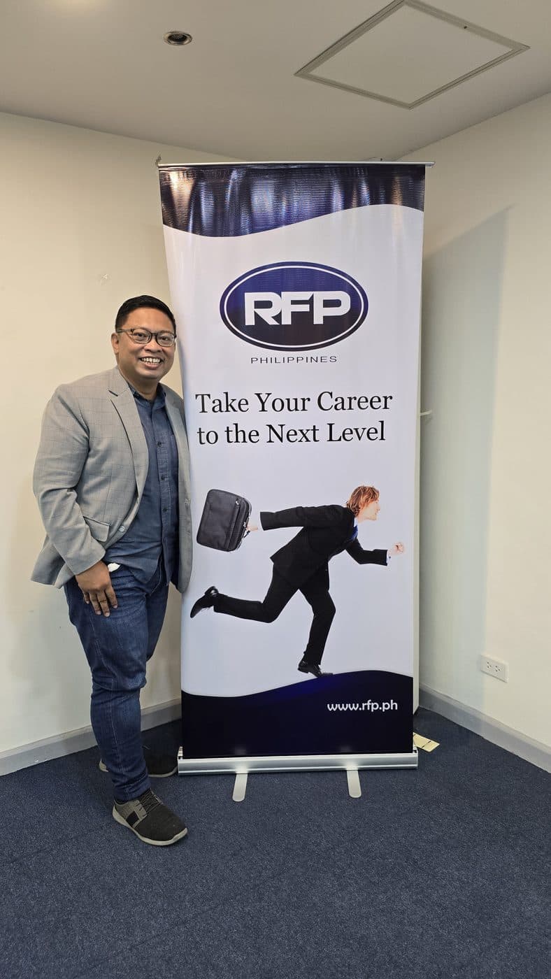 Kuya Aries beside a Registered Financial Planner Philippines banner